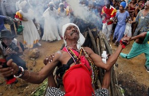 A Santero priest prays during an African-Cuban religious Santeria ceremony in honor of slaves rebelliousness, as part of the 30th Caribbean Festival in Loma del Cimarron, El Cobre, Cuba, Wednesday, July 7, 2010. The annual cultural event, that is dedicated to the Caribbean island of Curacao and the Brazilian state of Pernambuco, features religious ceremonies, street shows, concerts, conferences and art exhibits. (AP Photo/Javier Galeano)